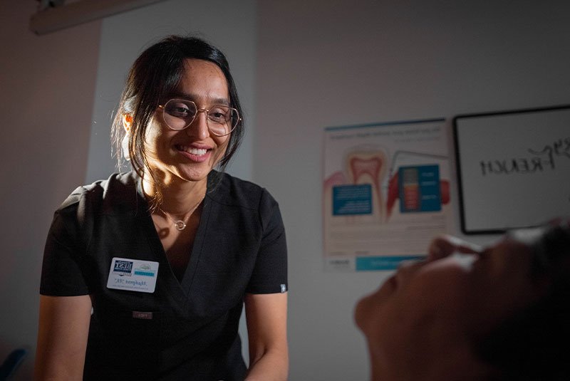 staff member helping patient during dental treatment