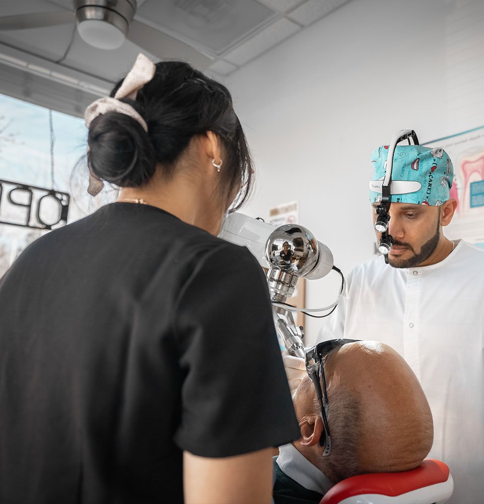 doctor performing procedure with patient within the dental center