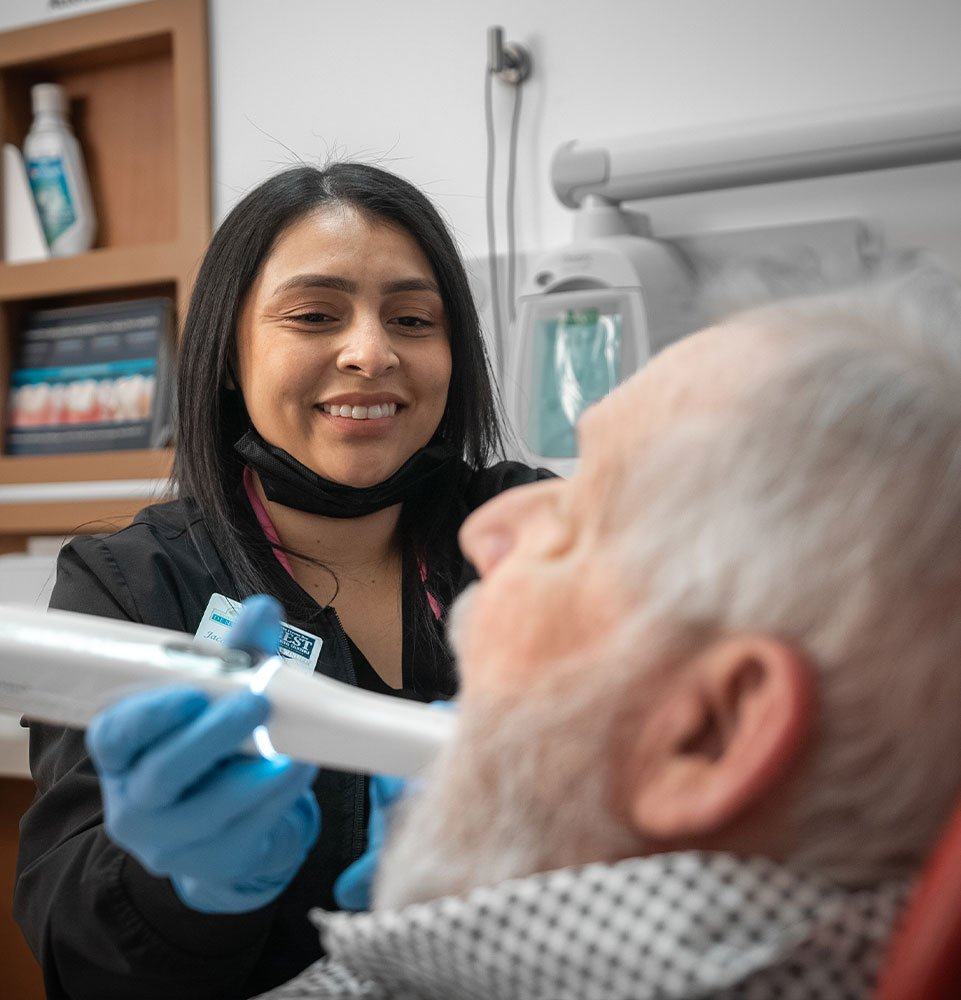 staff member using the intra oral scanner for patient dental treatment